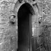 View of arched doorway with carving above.