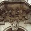 View of carved head of a boy and inscription, on keystone above entrance to Paisley Close.