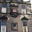 View of Pleasance facade, showing clockface and inscribed panel.