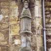 View of herm of bearded knight, to right of first floor central arched window on N facade.