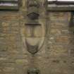 View of half-length female (top) and winged female bust (below), on gable above central arched window on N facade.