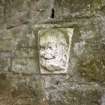 View of bearded male head, on E outer elevation of walled garden, at ground floor level.