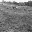 View of depression before excavation, taken from the S. An image from the Buteshire Natural History Society archaeology photograph album, held at Bute Museum.
