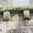 Detail of two corbels on apse