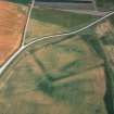 Oblique aerial view centred on the cropmarks of the moated site, taken from the west north west.