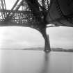 View across the Forth looking up from underneath the Forth Bridge showing the structure.