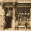 Historic photograph showing general view of shop front at No 8, A Mackie Cutler & Optician, Melbourne Place, Edinburgh. Since demolished.