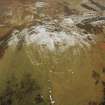 White Meldon, oblique aerial view, taken from the S, centred on the fort and a cairn.