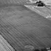 Oblique aerial view of Kaeheughs, Barney Mains, showing cropmarks of enclosure and pit-alignments

