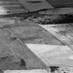 Oblique aerial view centred on the cropmarks of the pit-alignments with fort adjacent, taken from the S.