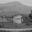 Distant view of St Fillans village and Drummond Arms Hotel, from across Loch Earn.
