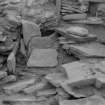 Excavation photograph: House 2, Tumbled stones in S. W. corner; Deliberate blocking of passage adjoining house 1 visible top.
