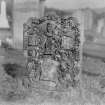 General view of gravestone with sock and coulter of the plough, and armorial devices.
