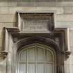 Detail of carved panel above doorway on north side of courtyard