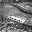 Glasgow, general view, showing Hoover (Electric Motors) Ltd. Cambuslang Works, Somervell Street and Bogeshole Road Bridge.  Oblique aerial photograph taken facing north.