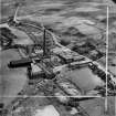 Robert Craig and Sons Ltd. Caldercruix Paper Mills, Airdrie Road, Caldercruix.  Oblique aerial photograph taken facing south-east.  This image has been produced from a crop marked negative.