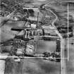 Robert Craig and Sons Ltd. Caldercruix Paper Mills, Airdrie Road, Caldercruix.  Oblique aerial photograph taken facing east.  This image has been produced from a crop marked negative.