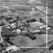 Robert Craig and Sons Ltd. Caldercruix Paper Mills, Airdrie Road, Caldercruix.  Oblique aerial photograph taken facing south-west.  This image has been produced from a crop marked negative.