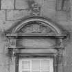N facade. Detail showing segmented pediment with flower finial
