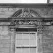 N facade. Detail showing segmented pediment broken by star finial