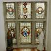 Interior, view of second floor staircase stained glass window with heraldic devices and St Andrew
