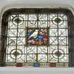 Interior, view of ground floor library stained glass window of a goldfinch in blossom