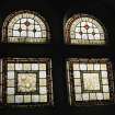 Interior, view of basement stained glass window inscribed"EAST OR WEST HAMES BEST NORTH OR SOUTH LOVE IS WORTH"