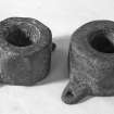 Octagonal copper-alloy bearing coaks, either from the centres of wooden sheaves or possibly the mounting of a swivel-gun. The larger is 9 cm in diameter and 6 cm deep; the smaller 8 cm in diameter and 5 cm deep.