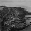 Gourdon, general view, showing Gourdon Harbour and W Peter and Co. Ltd. Selbie Works.  Oblique aerial photograph taken facing east.  This image has been produced from a print.