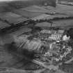 J and W Somerville Ltd. Kali Nail Works, Station Road, Lennoxtown.  Oblique aerial photograph taken facing west.  This image has been produced from a print.