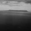 Eigg, general view.  Oblique aerial photograph taken facing west.  This image has been produced from a damaged print.