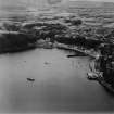 Tobermory, general view, showing Main Street and Ledaig Distillery, Eas Brae.  Oblique aerial photograph taken facing west.  This image has been produced from a print.