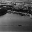 Tobermory, general view, showing Main Street and Ledaig Distillery, Eas Brae.  Oblique aerial photograph taken facing west.  This image has been produced from a damaged print.