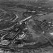 Temple and Dawsholm Gas Works, Maryhill, Glasgow.  Temple Gasholder Nos 4 and 5 are visible (top), Garscube Chemical Works and Dawsholm New Chemical Works are on the right beyond the railway sidings. Oblique aerial photograph taken facing west.  This image has been produced from a print.
