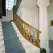 Interior. Detail of staircase showing square columns and curved balustrade