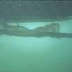 The cradled keel section suspended below the inflatable boat for transport ashore.