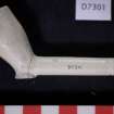 Clay pipe bowl and part of stem with rouletted decoration, D7301. Scale in centimetres.