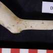 Broken clay pipe bowl and part of stem, D7124. Scale in centimetres.