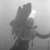 Tony Long carrying one of the loose timbers ashore. 	
