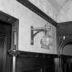 Interior.  Detail of wall lamp and bracket.