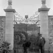 Detail of north gates, Newton Don walled garden, with two men.