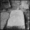 Excavation photograph, detail of incised cross-slab.