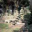 General view showing steps, fragments and gravestones, Hutton Churchyard.