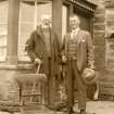 Scanned image of photograph of John Nicolson and unidenified man standing outside Summerbank House, Auckengill