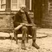 Scanned image of photograph of John Nicolson seated outside his home holding a horn, Summerbank House, Auckengill
