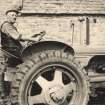 Scanned image of photograph of Bill Nicolson sitting on a tractor