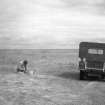 RCAHMS Archaeologist Alastair MacLaren and the first RCAHMS Land Rover, probably at Drimore, South Uist.