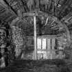 Interior of cart shed, cruck-frame and roof groundwork formed of salvaged ships' timber; Laidhay, Caithness.