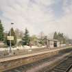 View from SW of N-bound platform, including waiting room and shelter, and station garden