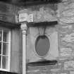 Detail of rainwater hopper and oval window